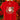 A bright red short-sleeve t-shirt hanging on a wooden hanger, featuring a festive Christmas graphic with the word 'JOY' in large letters, Santa's face, a candy cane, and the phrase 'To the world' in cursive. The background shows a blurred Christmas tree with warm lights and red poinsettias.