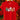 A bright red short-sleeve t-shirt hanging on a wooden hanger, featuring a colorful Christmas-themed graphic print of a tree, snowman, hot cocoa, gingerbread man, and candy cane. The background is a warm, festive holiday scene with blurred Christmas lights and poinsettias.